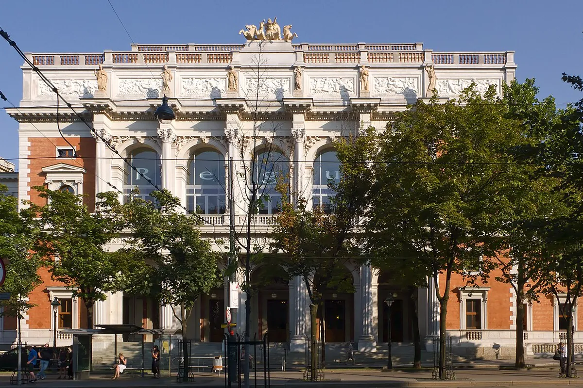 The central front of the old Börse in Vienna, with tall arched windows between slender columns and a sculpted frieze under the roofline